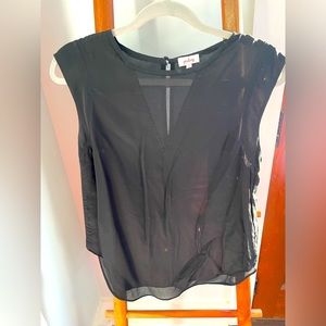 Black silk top with some shear detailing on the neckline and back hemline